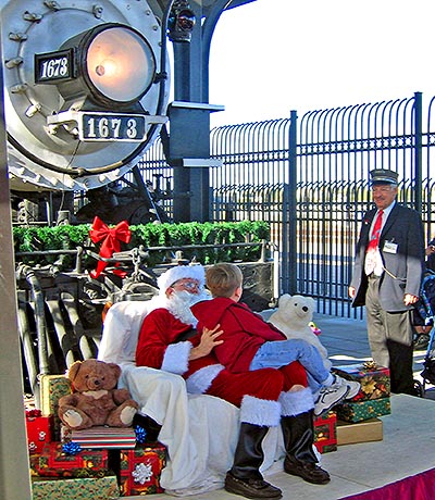 Santa, child, and conductor